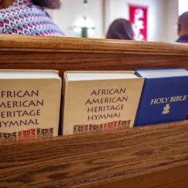 The Holy Bible and the Agrican American Heritage Hymnal along the pews of Christ Presbyterian Church