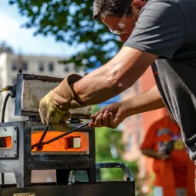 Blacksmith Jeff Wild removes metal from a forge.