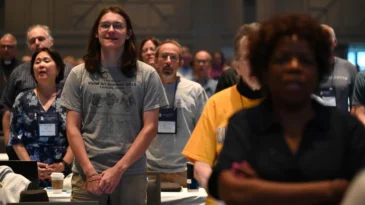 a group of people standing in worship