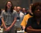 a group of people standing in worship