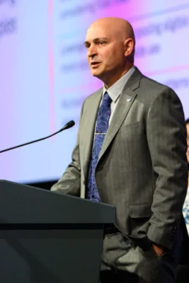 A man stands behind a podium