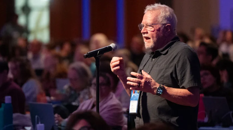 A man speaks behind a microphone