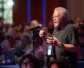 A man speaks behind a microphone