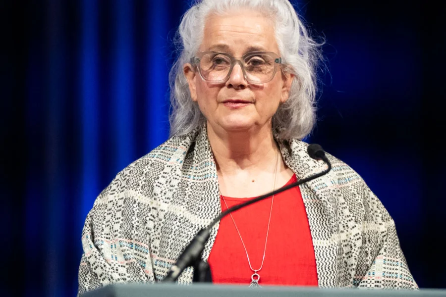 A woman speaks into a microphone 