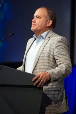A man speaks behind a podium