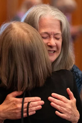 Two women hug