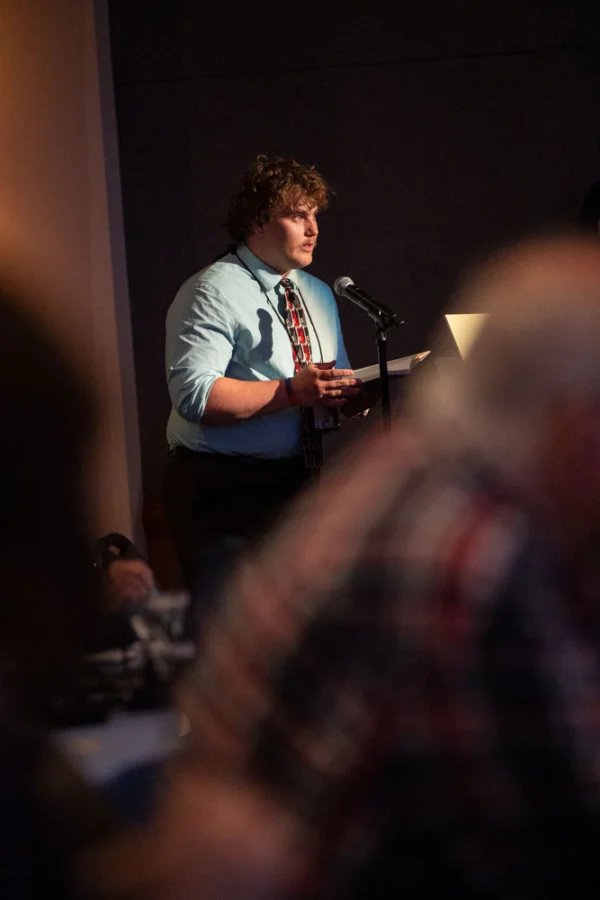 A man speaks at a microphone