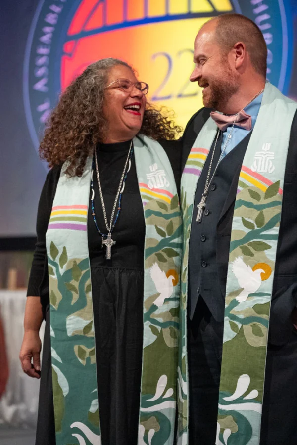 The Rev. Marta Pumroy-Cordero and the Rev. Dr. Kristopher D. Schondelmeyer stand next to each other on the stage of GA227.