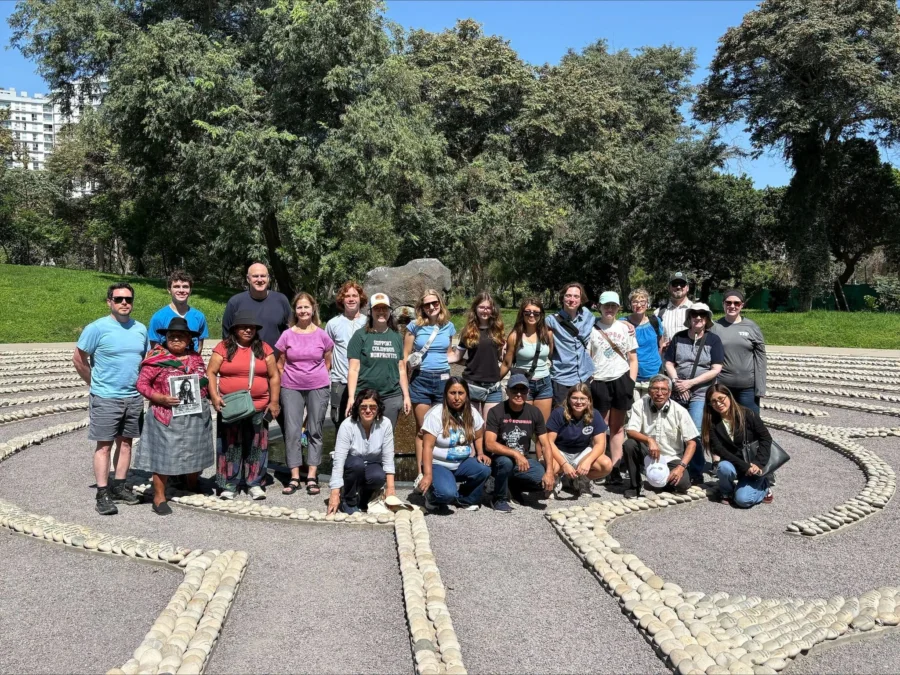 A group of people take a picture standing in a labyrinth.