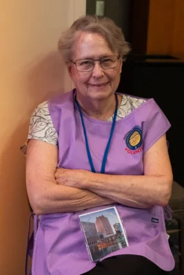 A volunteer in a purple vest.