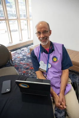 A volunteer in a purple vest.