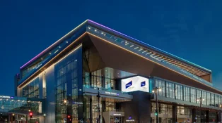 A glass building lit up in twilight.