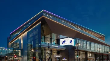 A glass building lit up in twilight.
