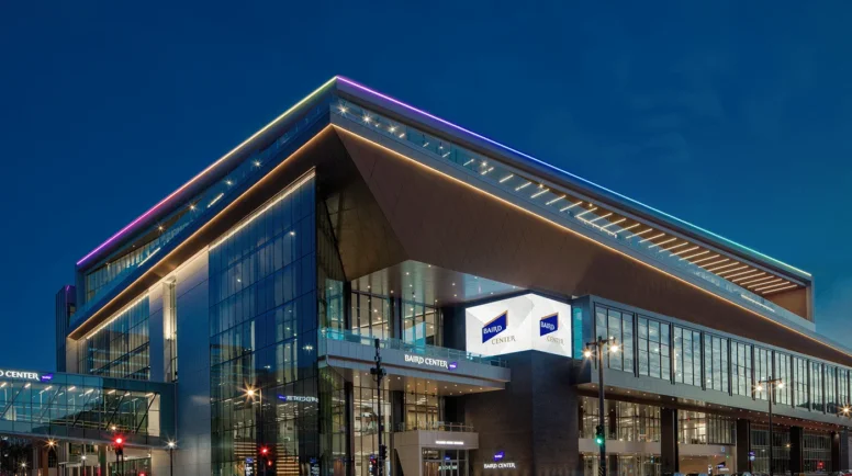A glass building lit up in twilight.