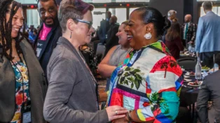 Two women embrace