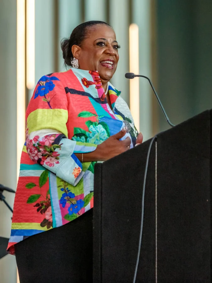 Diane Moffett stands behind a podium