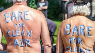 Two participating of the Naked Bike Ride with painted backs stating "Bare for Clean Air"