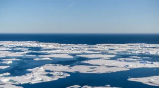 Small patches of ice in the water of the arctic ocean.