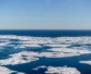 Small patches of ice in the water of the arctic ocean.
