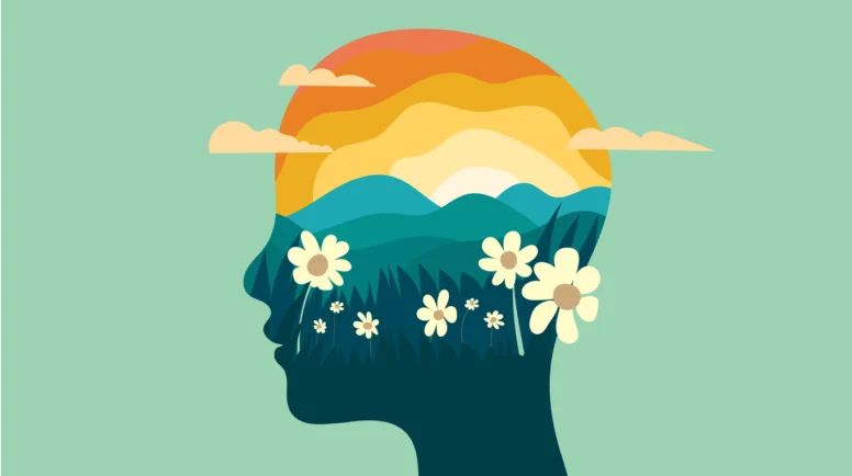 The outline of a head with illustrations of sunrise mountains and flowers inside the silhouette.