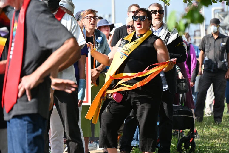 People in stoles gather outside