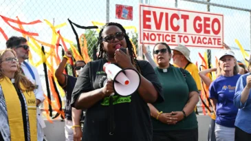 A woman speaks into a bullhorn