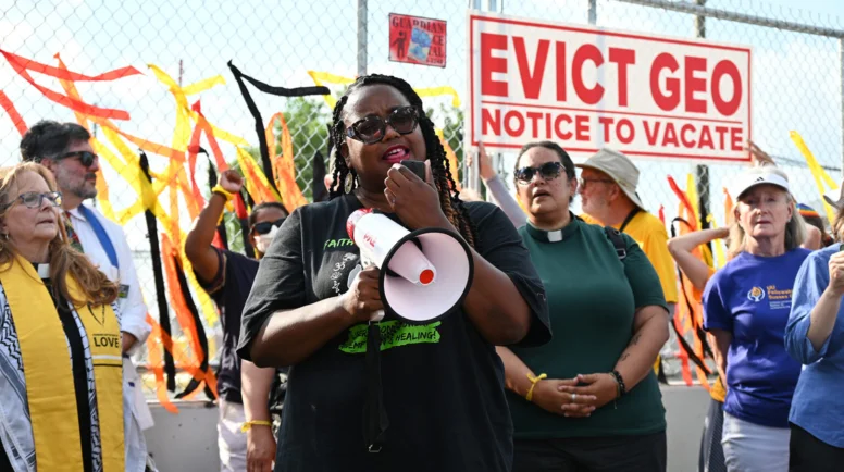 A woman speaks into a bullhorn