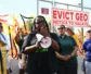 A woman speaks into a bullhorn