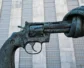 A statue of a gun with a knot at the end of it.