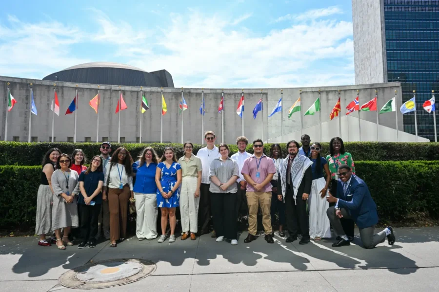 A group of Presbyterian Young Adult Delegates take a picture outside of the United Nations.