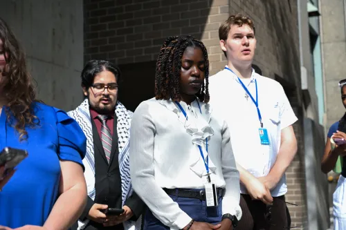 A group of Presbyterian young adults stand outside.