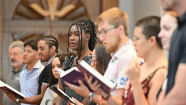 Young adults sing in worship.
