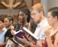 Young adults sing in worship.