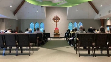 People sit in the sanctuary of Tualatin Presbyterian Church in Tualatin, Oregon.
