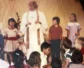 A vintage photo of Joanna Adams standing amongst children.