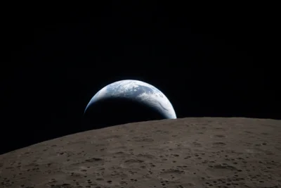 Photo of Earth from space, with part of the moon in the forefront