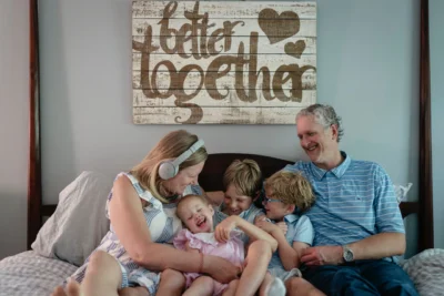 The Shell family poses for a family photo with their three small children and two parents.
