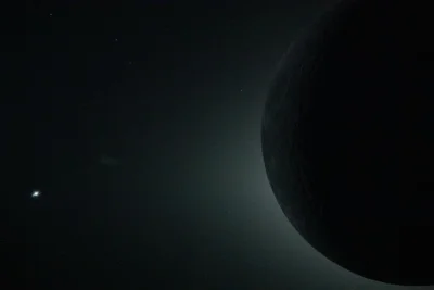 Close up view of earth from a spacecraft, mostly in darkness