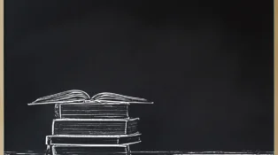 Black chalkboard frame with stacked and open books