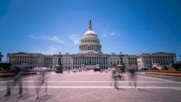 Wide Angle View of the US capitol during Day time with Blue Skies and tourists