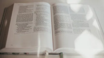 Open bible with light shining on it.
