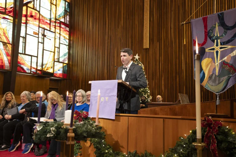 Democratic candidate for U.S. Senate and state Rep. James Talarico stands in a church behind a podium.