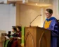 Union Presbyterian Seminary President Jacqueline Lapsley stands behind a podium in academic robes.