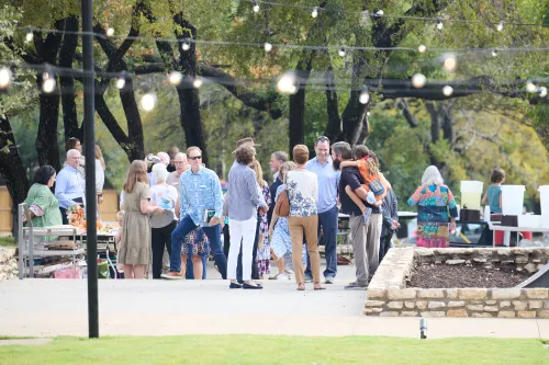 People gather on a patio outside Covenant Presbyterian Church in Austin, Texas.