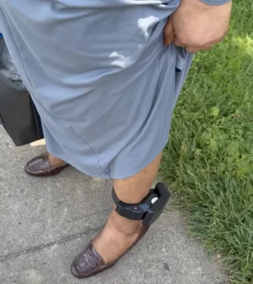 A photo of a woman's ankle with a monitor on it.