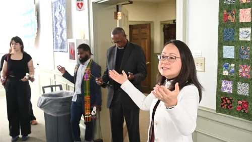 The Rev. Jihyun Oh spreads her hands in blessing and prayer.