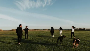 A group of young people walking across a field