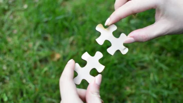 Two puzzle pieces being put together