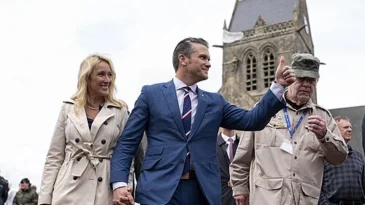 Pete Hegseth and his wife Jennifer in front of church