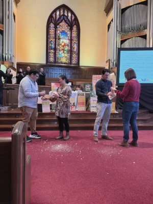 Breadcrumbs fall to the floor during communion in a church sanctuary